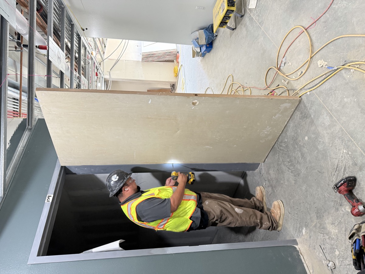 Monterey Bay Door crew hanging a commercial wood door in a steel frame